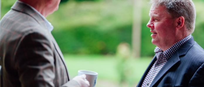 team members talking at an event